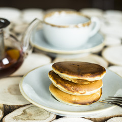 Pancakes with chocolate inside on a wooden table of log cabins. Rustic style. Concept of homemade food