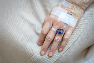 Patient's hand in the hospital with saline intravenous (iv) drip