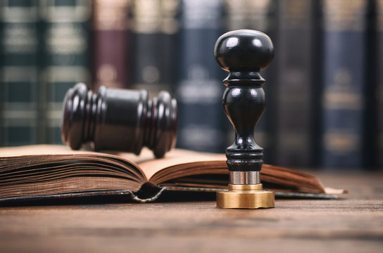 Notary seal and Judge Gavel on the wooden background, Notarized document concept, Legality concept.