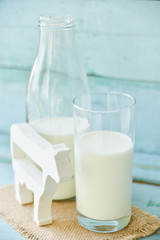 milk bottle, glass of milk, a figure of a cow the concept of rural food, fresh food