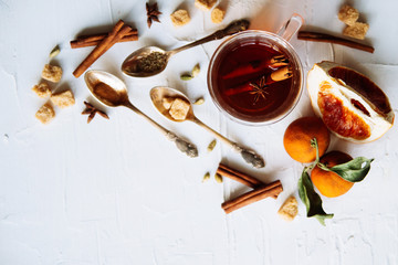Cup of herbal tea on dark aged rustic background, top view, place for text, border