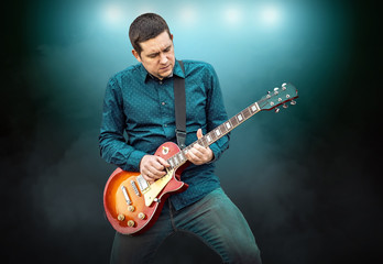Obraz premium Artist Guitarist hands play on electricity guitar under light, P