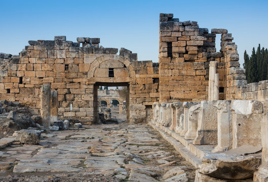 Ruins of Appollo temple with fortress at back in ancient Corinth, Peloponnese, Greece