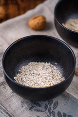 Breakfast. Oatmeal flakes in a bowl. Still-life on a wooden background.