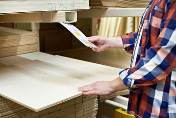 Man chooses plywood boards in store