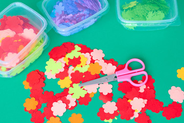 Scissors and paper flowers for applique. Preparation for the spring holiday.