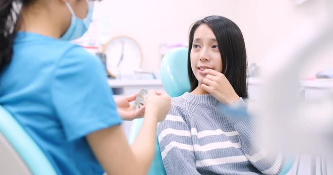 Woman undergo consultation with dentist at dental clinic