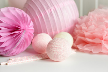 Various festive paper decor in pink color on white background. Free copy space. Wedding of birthday celebration concept.