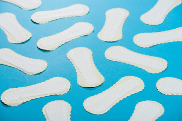 scattered protective daily pads on blue