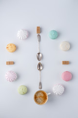 time to drink coffee. a clock in the form of coffee. macarons, sugar, marshmallows. creative and creative work.