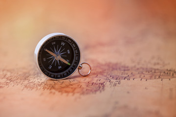 Fototapeta na wymiar Compass on vintage map. Travel and adventure Concept.