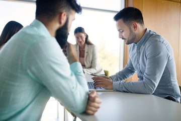 Picture of young architects discussing in office