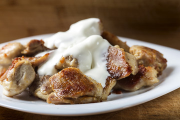 Fried chicken meat with sour cream