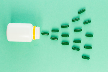Green pills or tablets spilled as a pattern