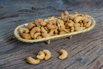 Cashew nuts in basket isolated on Wood background