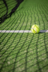 Paddle tennis court and net with a ball