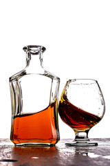 Glass of splash whiskey with bottle.