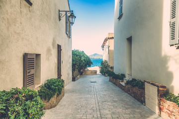 Street with white buildings leading to the sea, Saint Tropez, Provence, France, Cote d'Azur. French style architecture