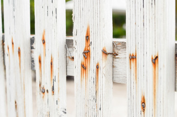 White wooden fence with rust.