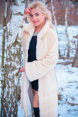 Close-up portrait of happy girl  enjoying winter moments. Outdoor photo of long-haired laughing lady having fun in snowy morning on nature background 