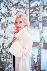 Close-up portrait of happy girl  enjoying winter moments. Outdoor photo of long-haired laughing lady having fun in snowy morning on nature background 