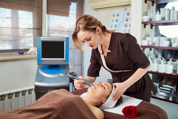Hardware treatments in the spa salon. Young woman at the cosmetician in the spa room.