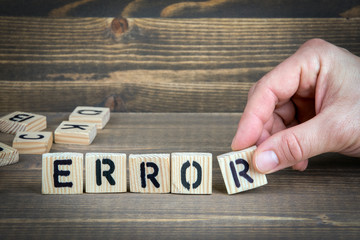 error. Wooden letters on the office desk, informative and communication background.