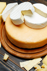 Various types of cheese - parmesan, brie, roquefort, cheddar