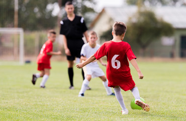 Obraz premium Young children players football match on soccer field
