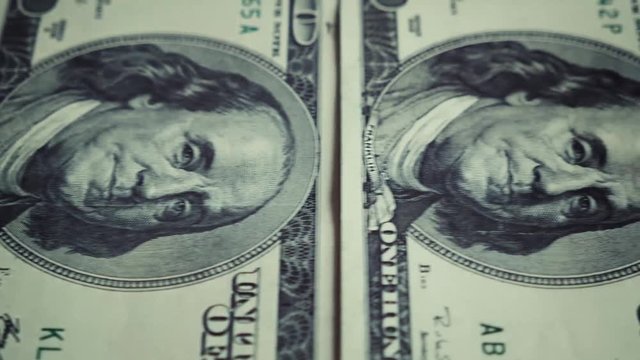 banknote 100 us dollar conveyor movement from the left to the right side with a stop close-up portrait of Benjamin Franklin