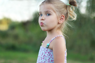 little cute little girl showing tongue. Emotion. Character