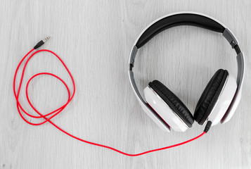 Headphone with red line on gray background.