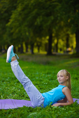 Girl doing gymnastic exercises or exercising outdoor