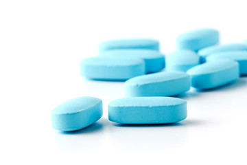 Pile of blue pills isolated on white