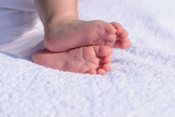 little baby foot on white blanket