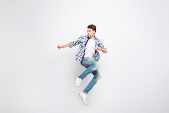 Mid-air shot of mad, crazy, cheerful, successful guy with bristle jumping, looking to the side, posing, gesturing against white background