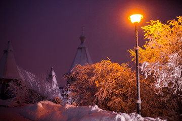 Romantic view of old traditional wooden house in scenic northern winter wonderland scenery in beautiful mystic twilight.