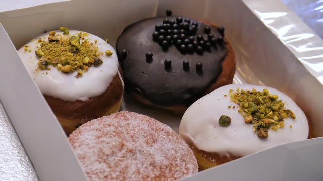 Close Up Box of Paczki Jelly Cream Filled Donuts Pastries on Fat Thursday Polish Traditional Holiday
