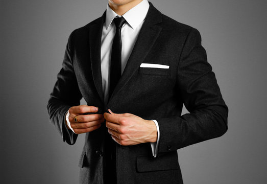 Businessman in a black suit, white shirt and tie. Studio shooting