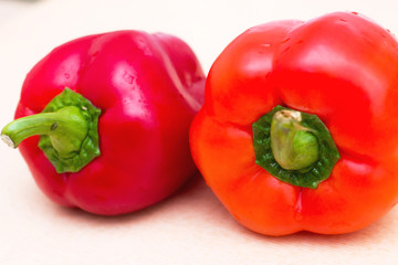 Two red sweet peppers with drops of water. Fresh vegetables for a healthy diet