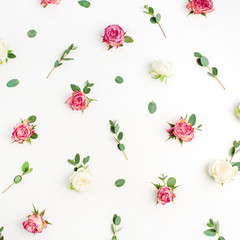 Fototapeta na wymiar Floral pattern made of red and white rose flower buds and eucalyptus branches on white background. Fat lay, top view flowers background.
