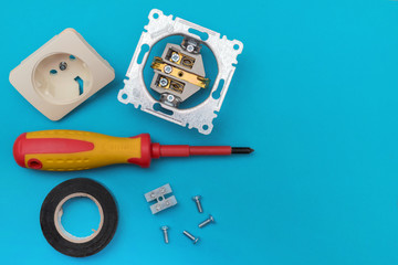 Tools electrician - screwdriver, screws, socket, electrical tape.
