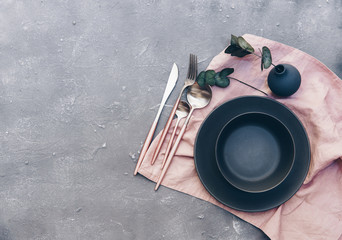 Rustic table setting with vintage ceramic plates and branch on blue old wooden table with copy space