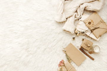 Minimalist Flat Lay Hipster Cozy home composition with sweater, craft elements and present