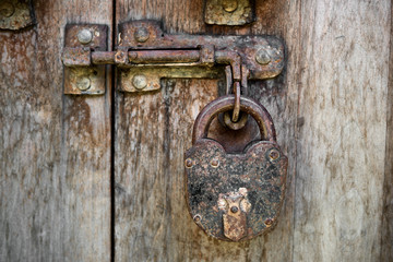 Vintage padlock on a old wooden door
