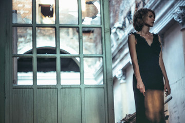 girl in a dress in an old house