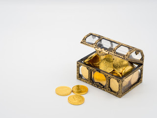 Little gold coins box in white background with space for text