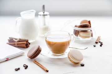 Breakfast with coffee and milk, some sweet french cookies. Morning time.