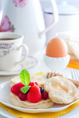 Vegetarian (lean) yeast pancakes with berries and honey, selective focus