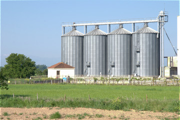 Fototapeta na wymiar Grain silo / grain silo unit at countryside / blue sky background